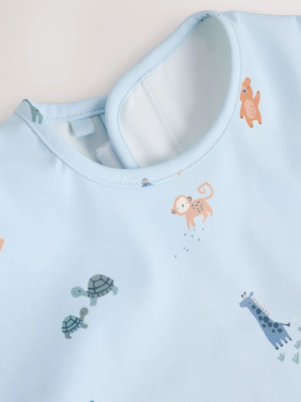 Blauw Dino Jungle - Slabbetje met mouwen voor spenen en voeden