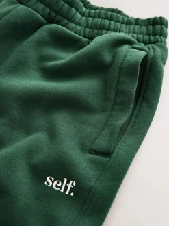 Groen - Self. joggingbroek met boorden