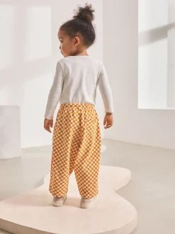 Oranje met dambordmotief - Broek met wijde kortere pijpen (3mnd -7jr)