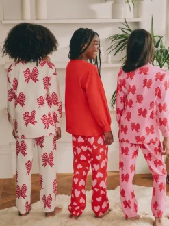 Rode strikken/hartjes - Verpakking van 3 pyjama's met joggingbroek (3-16 jr)