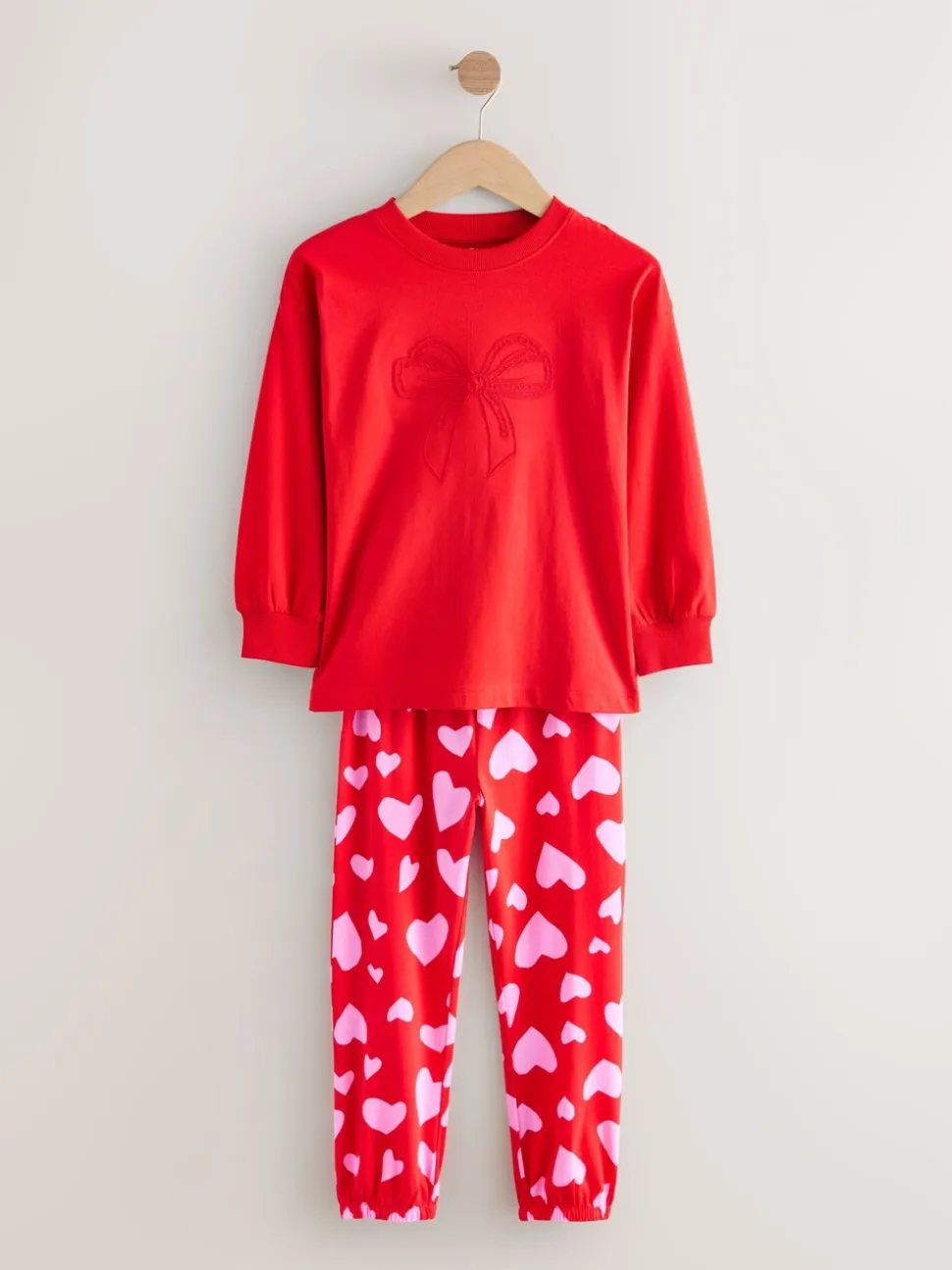 Rode strikken/hartjes - Verpakking van 3 pyjama's met joggingbroek (3-16 jr)