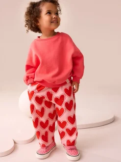 Rood met hartjesprint - Broek met structuur en wijde kortere pijpen (3mnd -7jr)