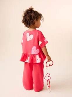 Rood met hartjesprint - T-shirt met peplum en korte mouwen (3mnd -7jr)