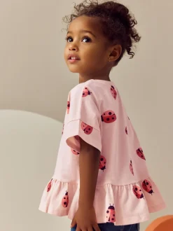 Roze lieveheersbeestje - T-shirt met peplum en korte mouwen (3mnd -7jr)