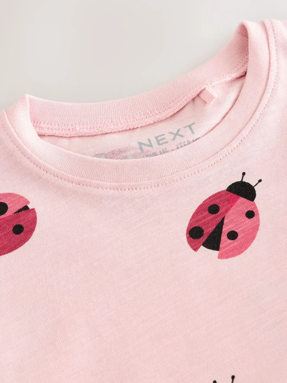 Roze lieveheersbeestje - T-shirt met peplum en korte mouwen (3mnd -7jr)