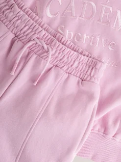 Roze met slogan - Set van sweatshirt en joggingbroek met wijde pijpen (3-16jr)