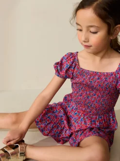 Roze met vrolijke print - Romper met smokwerk (3-16jr)
