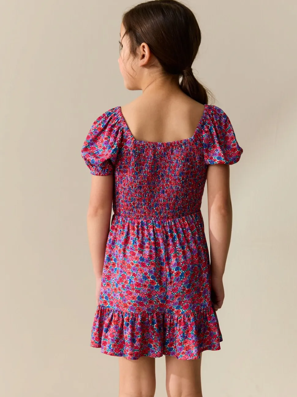 Roze met vrolijke print - Romper met smokwerk (3-16jr)