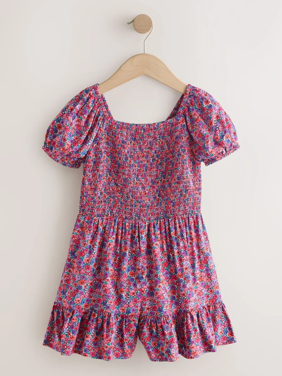 Roze met vrolijke print - Romper met smokwerk (3-16jr)