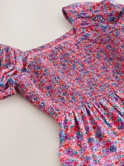 Roze met vrolijke print - Romper met smokwerk (3-16jr)